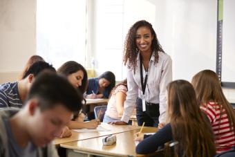 PHOTO-smiling-teacher-group-of-desks.jpg